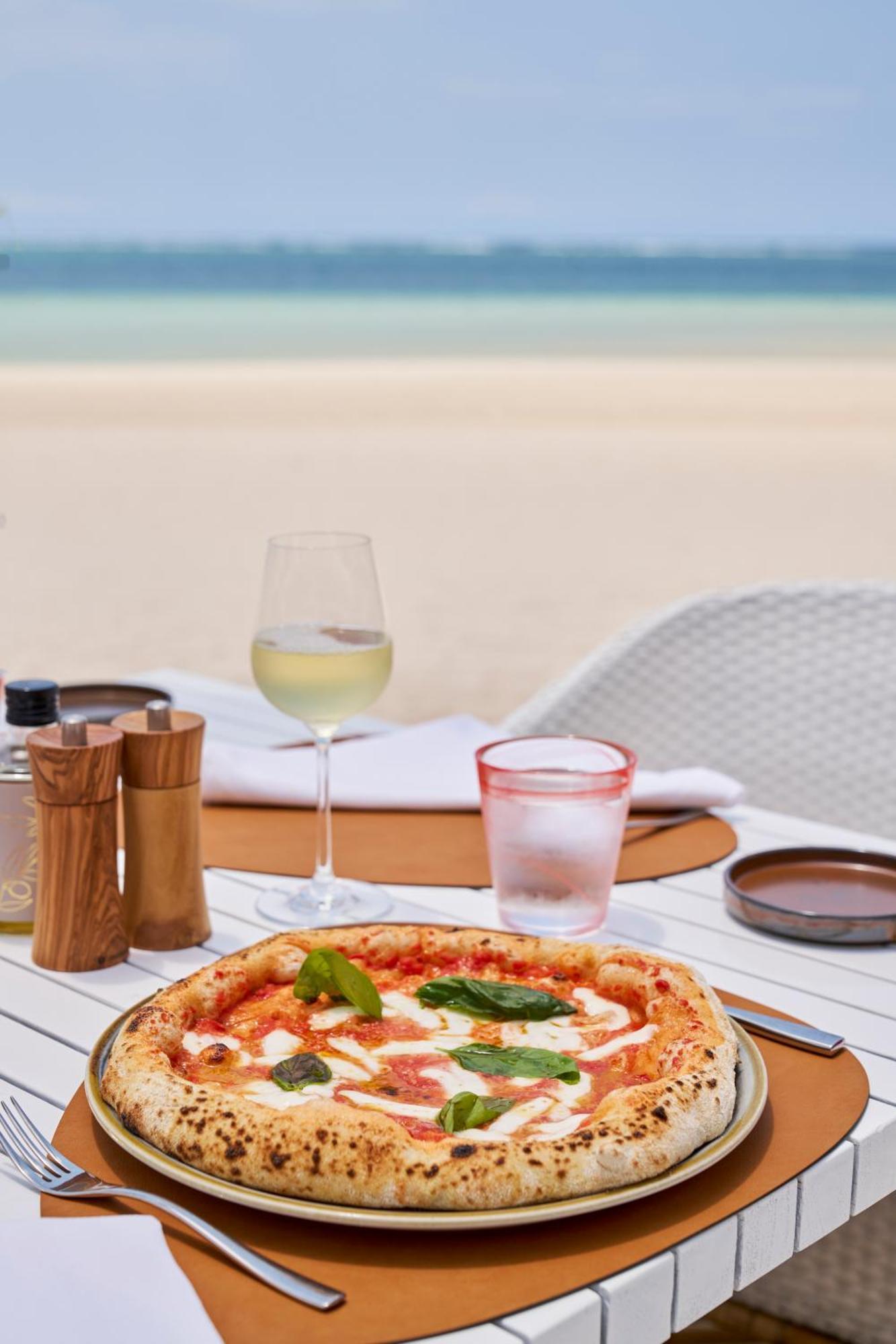 LUX* Belle Mare Resort&Villas Esterno foto A glass of wine with a pizza