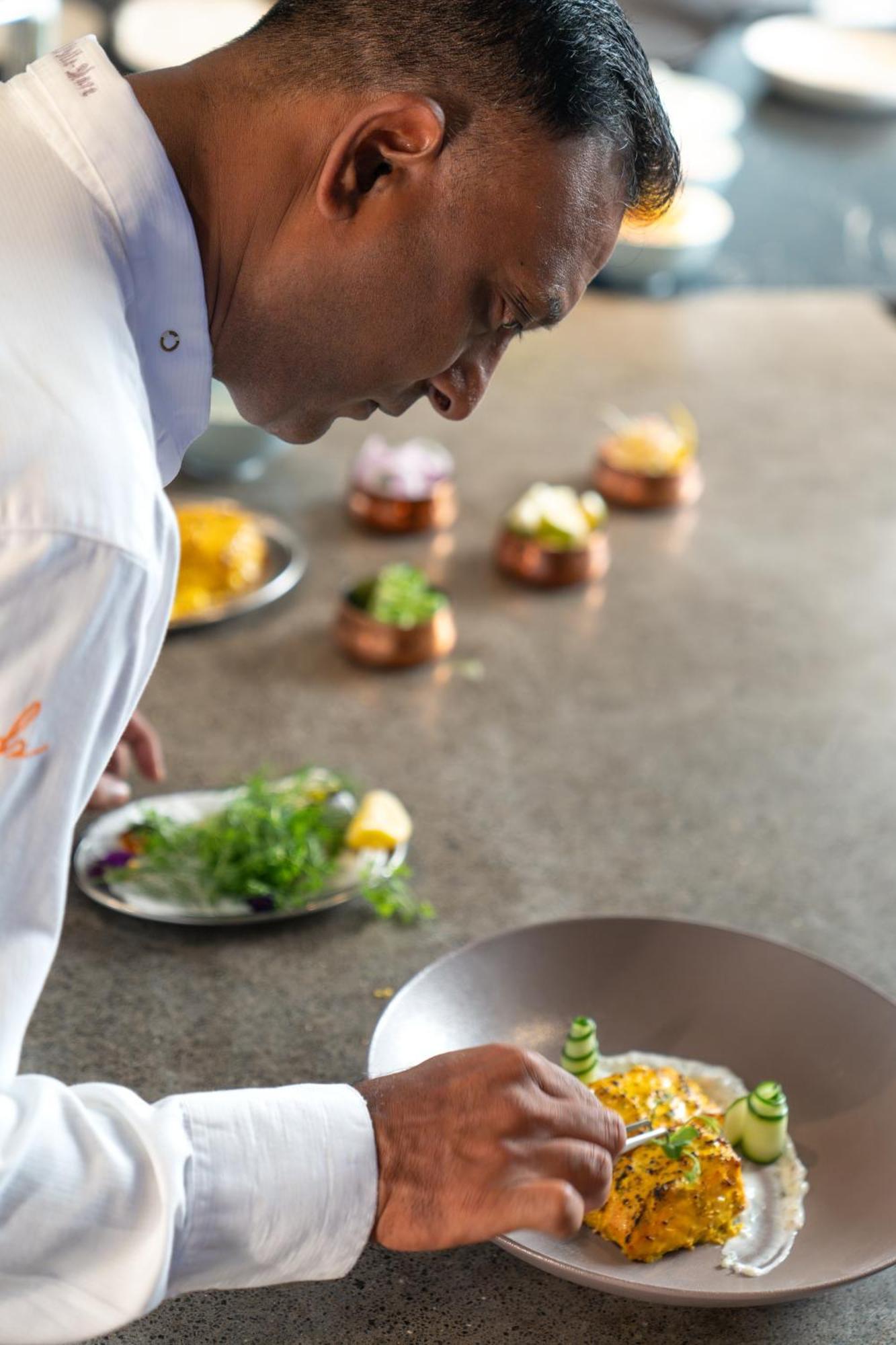 LUX* Belle Mare Resort&Villas Esterno foto A chef smelling food